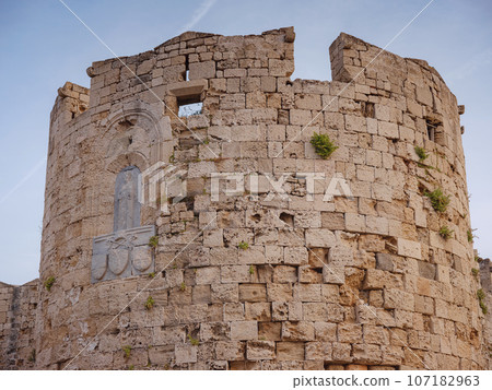 Travel to Greece, Mediterranean islands Rhodes. The walls of the medieval city of Rhodes, fortified stone walls of the fortification defense system of the old city. Travel to Greece, Mediterranean islands Rhodes. The walls of the medieval city of Rhodes, fortified stone walls of the fortification defense system of the old city. 107182963