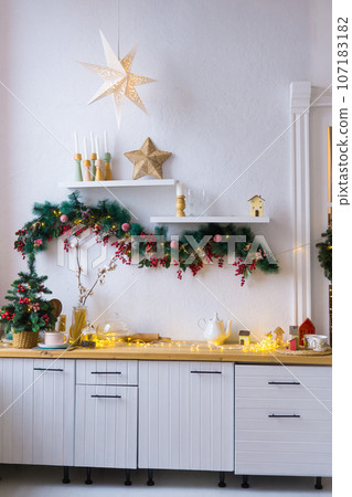 Kitchen interior decorated for Christmas and New Year. New Year's interior in red and white tones. 107183182