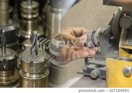 Abstract scene the tool regrinding process with tool sharpening machine. Abstract scene the tool regrinding process with tool sharpening machine. 107184093