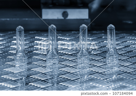 Close up scene of group of preform shape of PET bottle products. Close up scene of group of preform shape of PET bottle products. 107184094