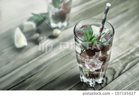 Homemade summer refreshing cocktail of fruits and berries. Homemade summer refreshing cocktail of fruits and berries. 107185027