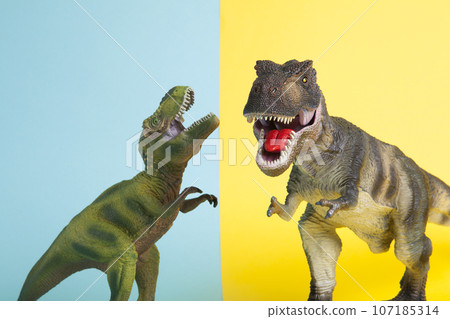 2 dinosaurs fighting on a yellow and blue background 2 dinosaurs fighting on a yellow and blue background 107185314