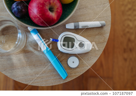 Close up of diabetes supplies and devices on table. Close up of diabetes supplies and devices on table. 107187097