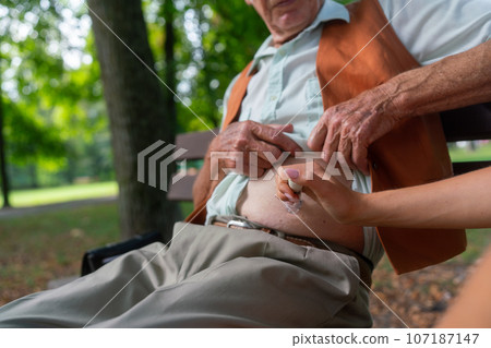 Nurse injecting insulin in belly of diabetic senior patient. Nurse injecting insulin in belly of diabetic senior patient. 107187147