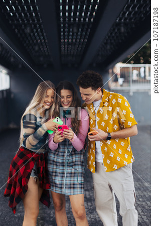 Generation z students hanging out together outdoors in the city. Generation z students hanging out together outdoors in the city. 107187198