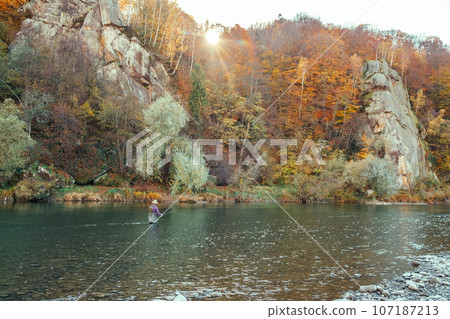 fishermen in autumn mountain river fishermen in autumn mountain river 107187213