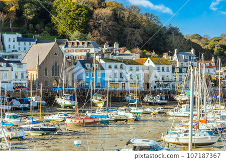 Saint Aubin town seashore view with Sacred heart of Jesus church,, and lots of yachts, bailiwick of Jersey, Channel Islands, Great Britain 107187367