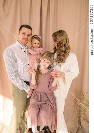 happy family of four father with mother and two daughters 107187393