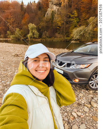 selfie woman near suv car at rocky beach 107187456