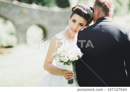 Sensual portrait of a young wedding couple. Outdoor Sensual portrait of a young wedding couple. Outdoor 107187684