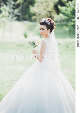 Beautiful fashion bride in wedding dress posing Beautiful fashion bride in wedding dress posing 107187685