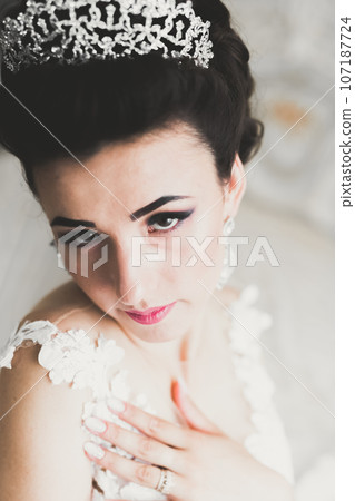 Portrait of beautiful bride with fashion veil at wedding morning Portrait of beautiful bride with fashion veil at wedding morning 107187724