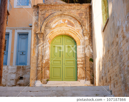 Cute details of windows, doors, balconies from old house in Simi island . Greece islands holidays from Rhodos in Aegean Sea. Colorful neoclassical houses in bay of Symi. Holiday travel background. 107187866
