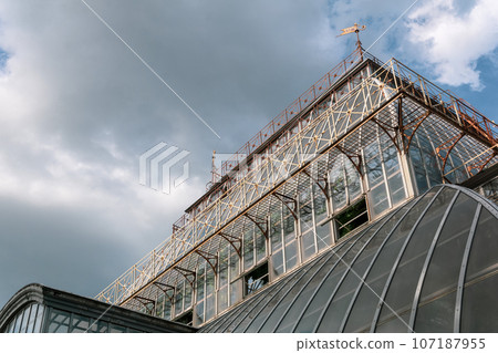 view of the glass dome of a large vintage palm greenhouse 107187955