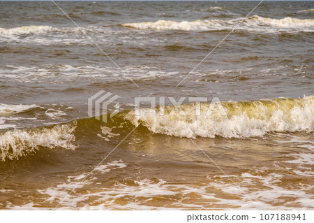 Atmospheric landscapes Dramatic Baltic Sea, waves and water splashes. Environment with volatile weather, climate change. Stormy, abstract backgrounds. The Gulf of Riga. 107188941