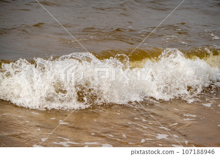 Atmospheric landscapes Dramatic Baltic Sea, waves and water splashes. Environment with volatile weather, climate change. Stormy, abstract backgrounds. The Gulf of Riga. Atmospheric landscapes Dramatic Baltic Sea, waves and water splashes. Environment with volatile weather, climate change. Stormy, abstract backgrounds. The Gulf of Riga. 107188946