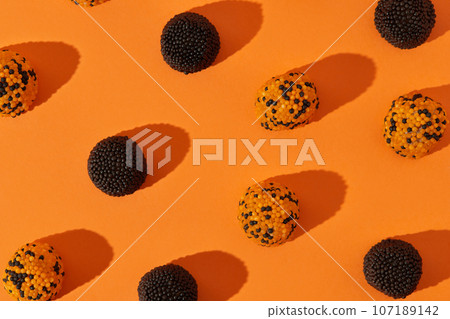Candy on orange background. Halloween wallpaper postcard greeting card 107189142