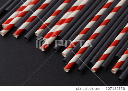 Black and red paper straws on black background. Halloween celebration party 107189150
