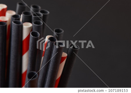Black and red paper straws on black background. Halloween celebration party 107189153