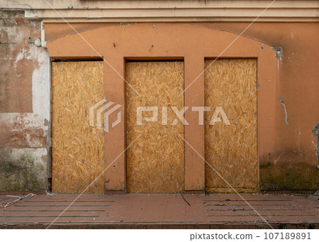 Abandoned Building with Boarded Up Windows, Old House Texture Background, Dilapidated Property 107189891