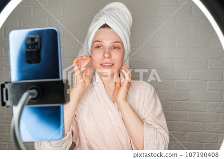 Selfie in the salon. A blogger with a mobile phone is recording a vlog Selfie in the salon. A blogger with a mobile phone is recording a vlog 107190408