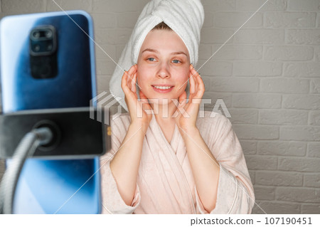 Pretty and smiling young woman live streaming about cosmetic products 107190451