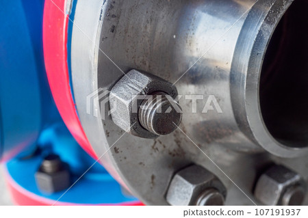 Close-up of steel pipe connection with bolts. Part of gas equipment. Gas industry. Background. 107191937