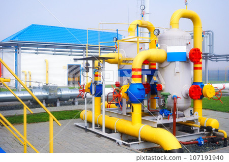 Gas distribution station. View of territory of gas distribution station with pipes and containers Gas distribution station. View of territory of gas distribution station with pipes and containers 107191940