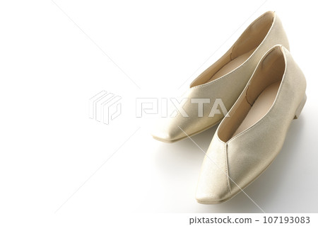 Low-soled gold women's shoes and pumps photographed against a white background Low-soled gold women's shoes and pumps photographed against a white background 107193083