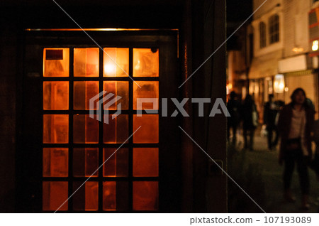 People walking in the night shopping street 107193089