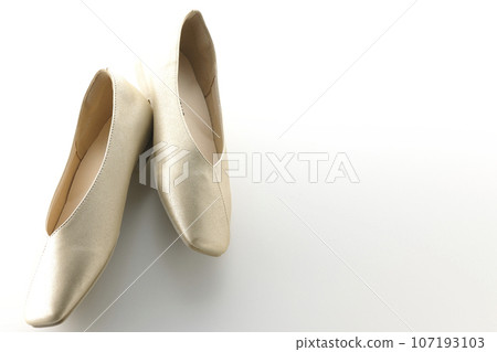 Low-soled gold women's shoes and pumps photographed against a white background 107193103