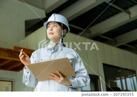 Women in work clothes, helmet 107193355