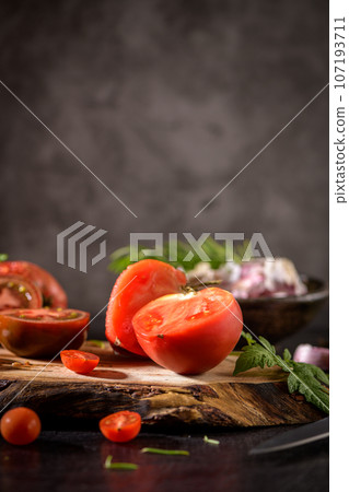Tomatoes on rustic kitchen counter Tomatoes on rustic kitchen counter 107193711