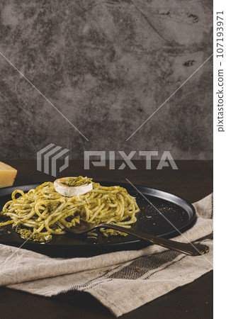 Fresh spaghetti with basil pesto and cheese Fresh spaghetti with basil pesto and cheese 107193971