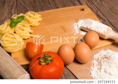Raw pasta, tomato and eggs Raw pasta, tomato and eggs 107194513
