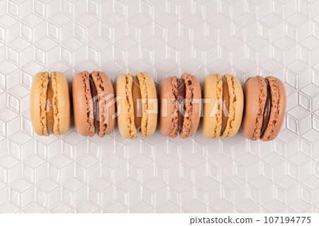 Six coffee and chocolated flavoured macaroons on vinyl background Six coffee and chocolated flavoured macaroons on vinyl background 107194775