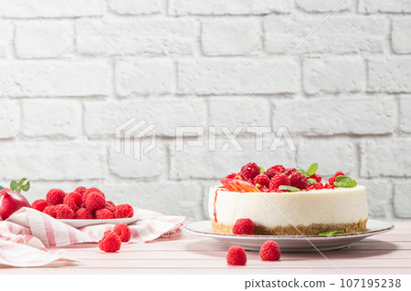 Cheesecake with fresh raspberries and plums 107195238