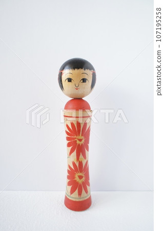 Kokeshi doll facing the front standing on a white background 107195258