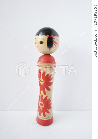 Kokeshi doll standing sideways on a white background 107195259