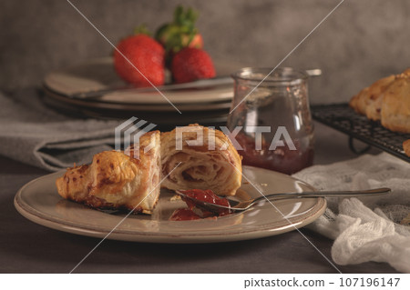 Baked croissants with strawberry jam 107196147