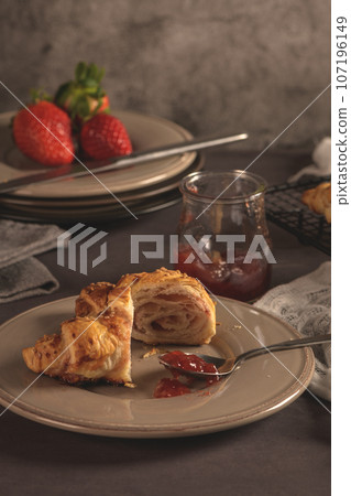 Baked croissants with strawberry jam 107196149
