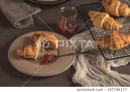Baked croissants with strawberry jam 107196157