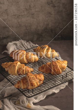 Baked croissants with strawberry jam 107196158