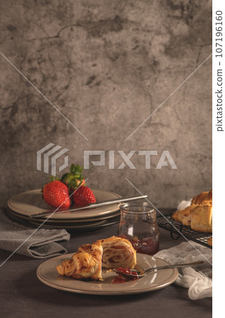 Baked croissants with strawberry jam 107196160