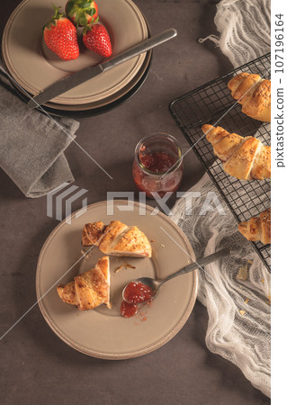 Baked croissants with strawberry jam 107196164