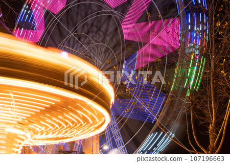 Spinning ferris wheel in motion Spinning ferris wheel in motion 107196663