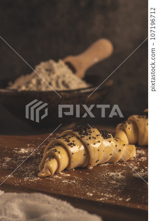 Raw croissant with ingredients 107196712