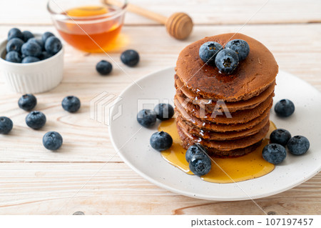 chocolate pancake stack with blueberry and honey chocolate pancake stack with blueberry and honey 107197457