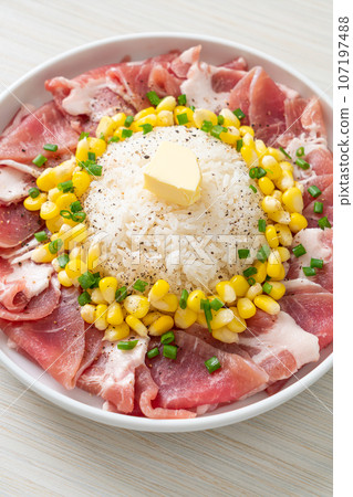 fresh pork raw sliced with rice and corn on plate and ready to cook 107197488