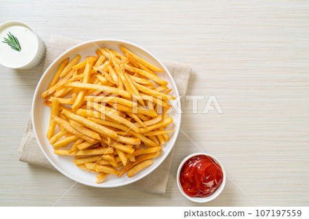 French fries with sour cream and ketchup 107197559